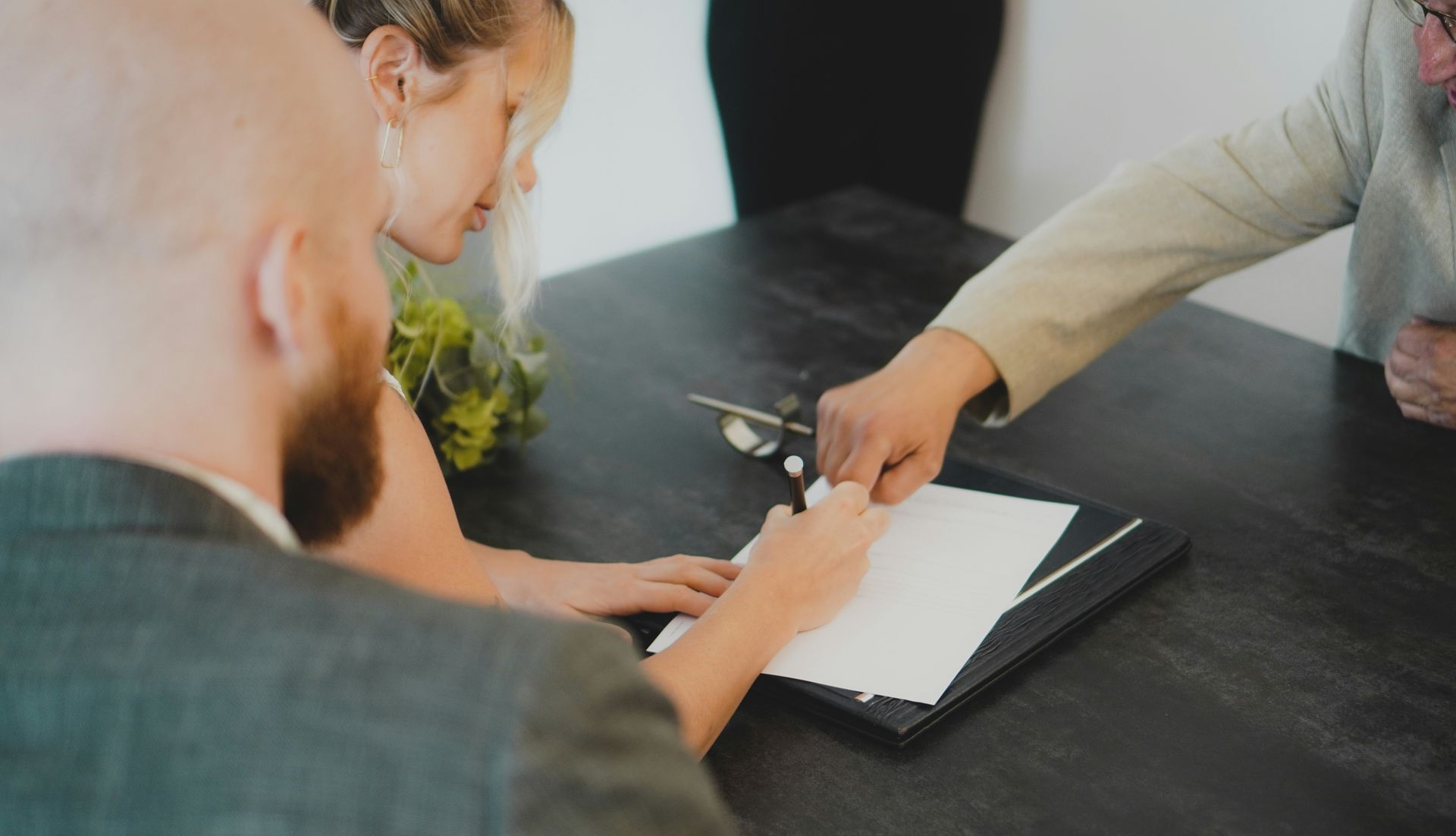 couple signing document at desk